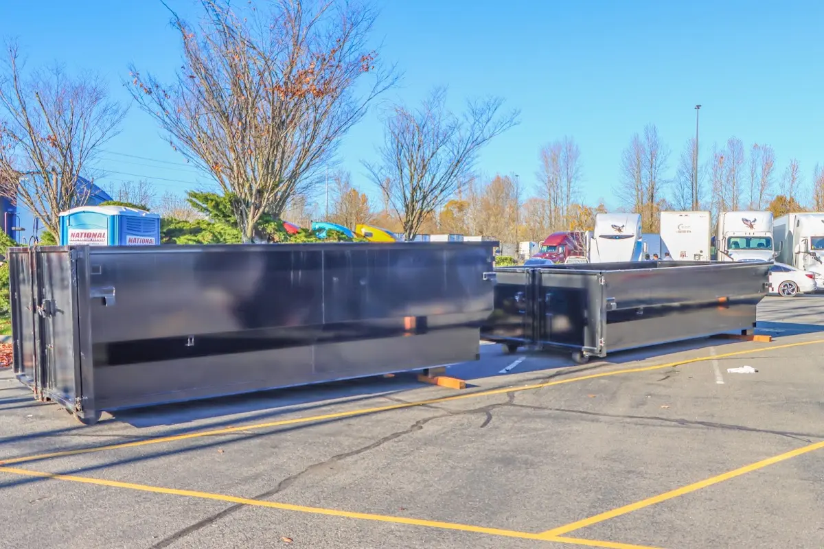 Professional dumpster rental service with roll-off container on residential driveway in Englewood Cliffs